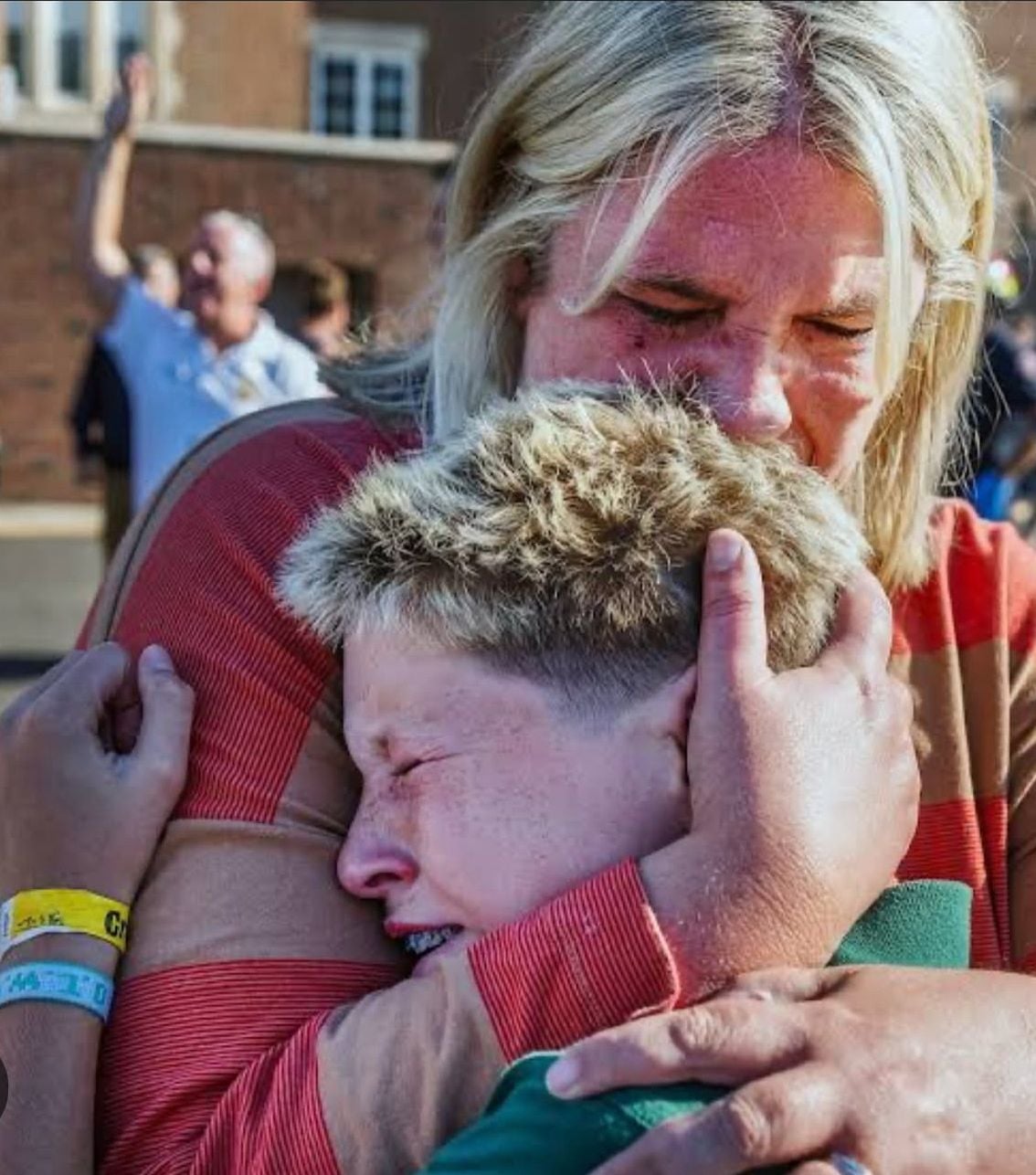 A mother consoles her traumatized child.